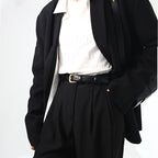 Stylish women's outfit featuring a jeans belt for women over a white top and black blazer