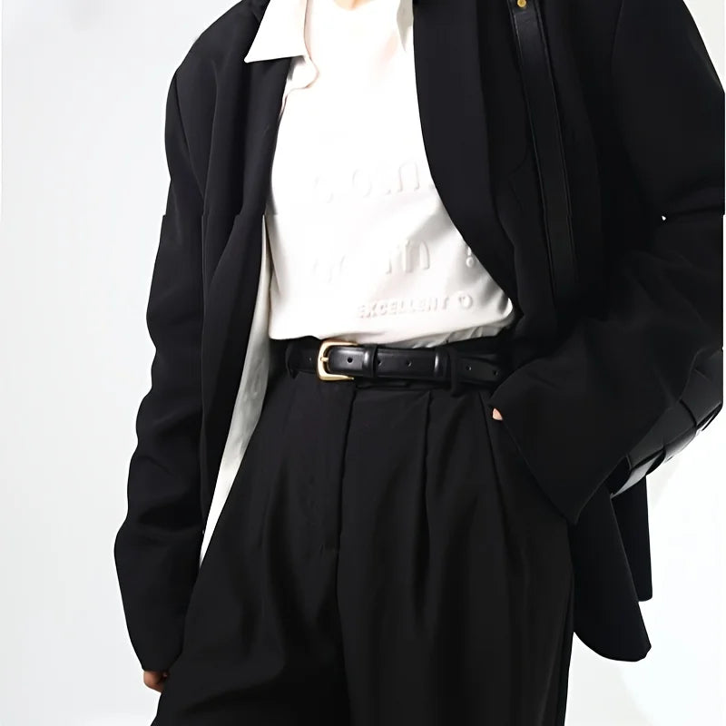 Stylish women's outfit featuring a jeans belt for women over a white top and black blazer