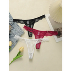 Set of black burgundy and white lace low waisted thongs displayed with denim and tulips