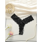 Black lace thong underwear for women displayed with pearls and flowers on white background