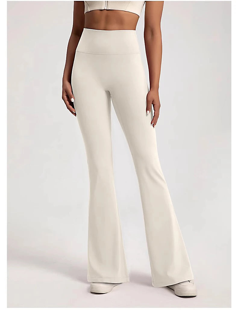 Stylish ladies bell-bottom yoga pants in white, designed for comfort and flexibility during workouts
