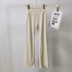 Cream ladies bell-bottom yoga pants with high waistband for comfortable workouts