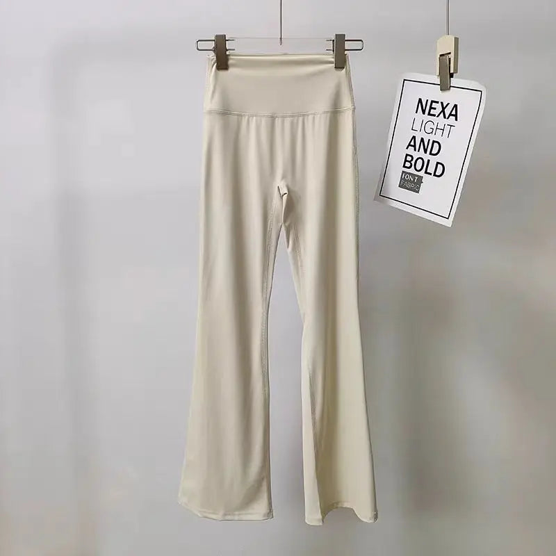 Cream ladies bell-bottom yoga pants with high waistband for comfortable workouts