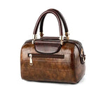 Stylish ladies designer shoulder handbag in brown with a structured design and top handles