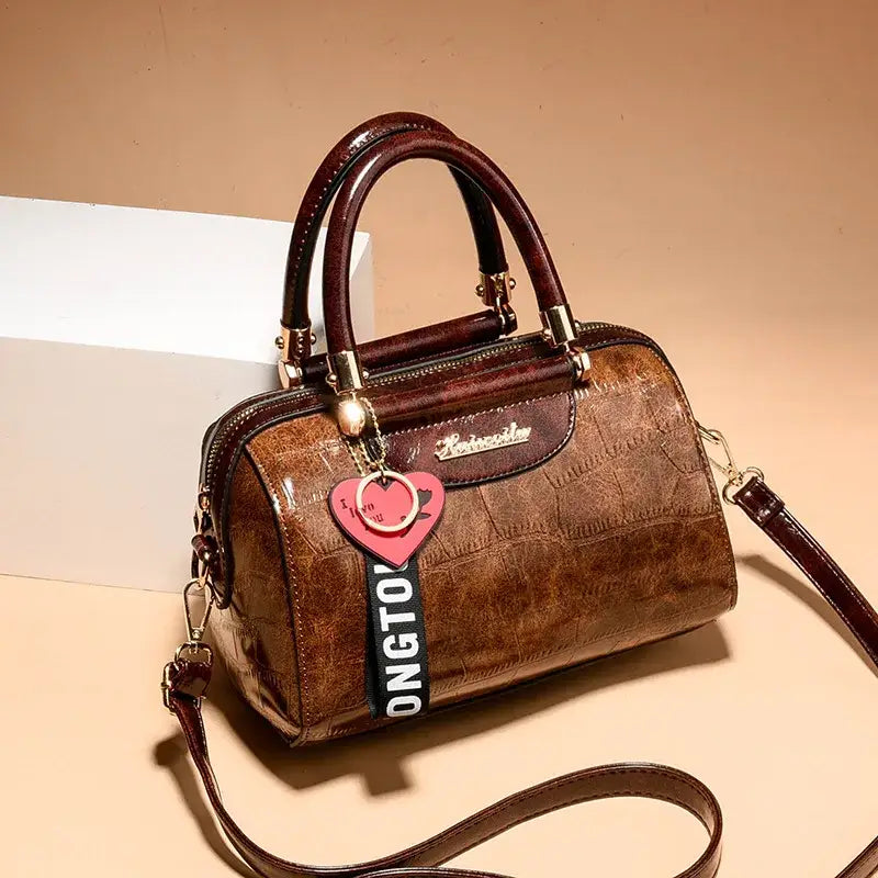 Ladies designer shoulder handbag in brown croc-embossed leather with stylish golden accents