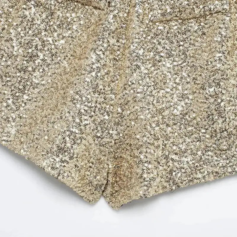 Close-up of elegant mid waist sequin shorts in gold with detailed shimmering sequins