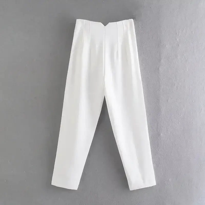 White elegant slim fit pencil trousers laid flat on gray background from The Lady's Haven Boutique