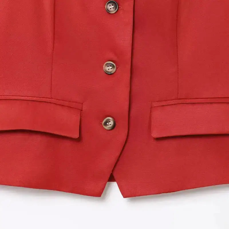 Close-up of red elegant spring summer waistcoat with buttons and front pockets