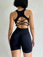 Ladies fitness clothing set in black featuring a stylish crisscross back and high-waisted shorts