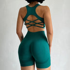 Ladies fitness clothing set in teal featuring a stylish crisscross back and fitted shorts
