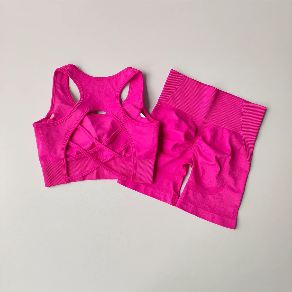 Bright pink ladies fitness clothing set featuring a stylish sports bra and matching shorts