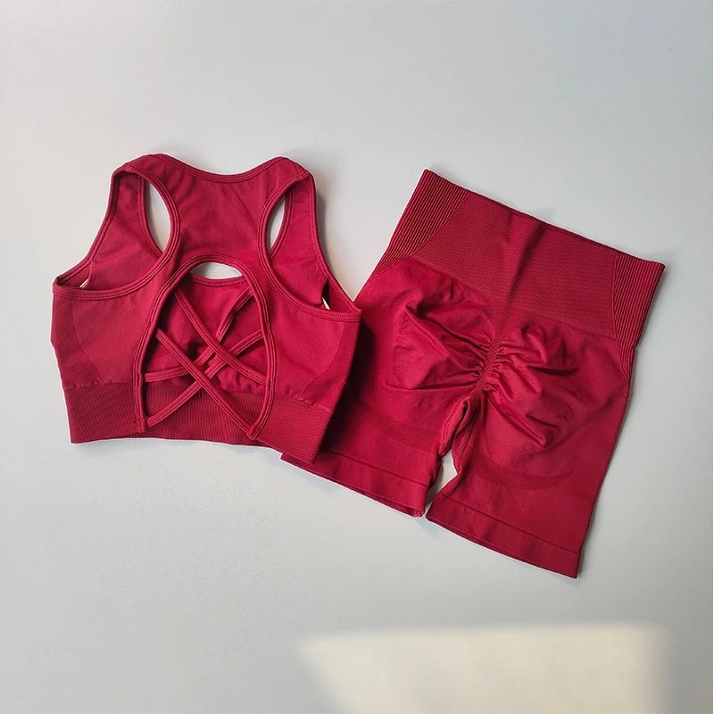 Ladies fitness clothing set in vibrant red with a crop top featuring a stylish back design and matching shorts