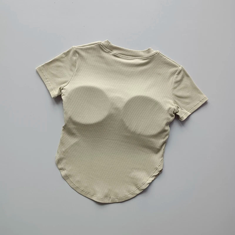 Beige ladies fitness crop tops with breathable fabric and a stylish rounded hem for active wear
