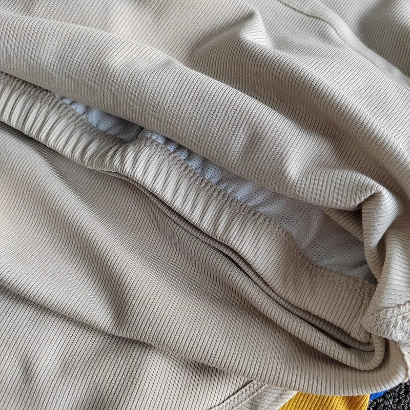 Close-up of beige fabric showcasing the texture of ladies fitness crop tops from The Lady's Haven Boutique