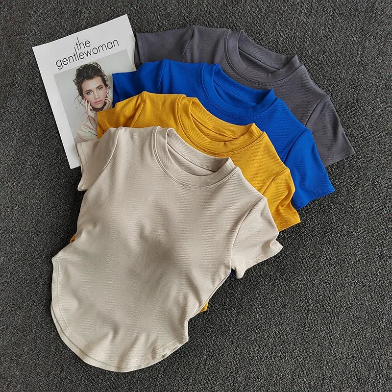 Assorted ladies fitness crop tops in beige, yellow, blue, and gray from The Lady's Haven Boutique