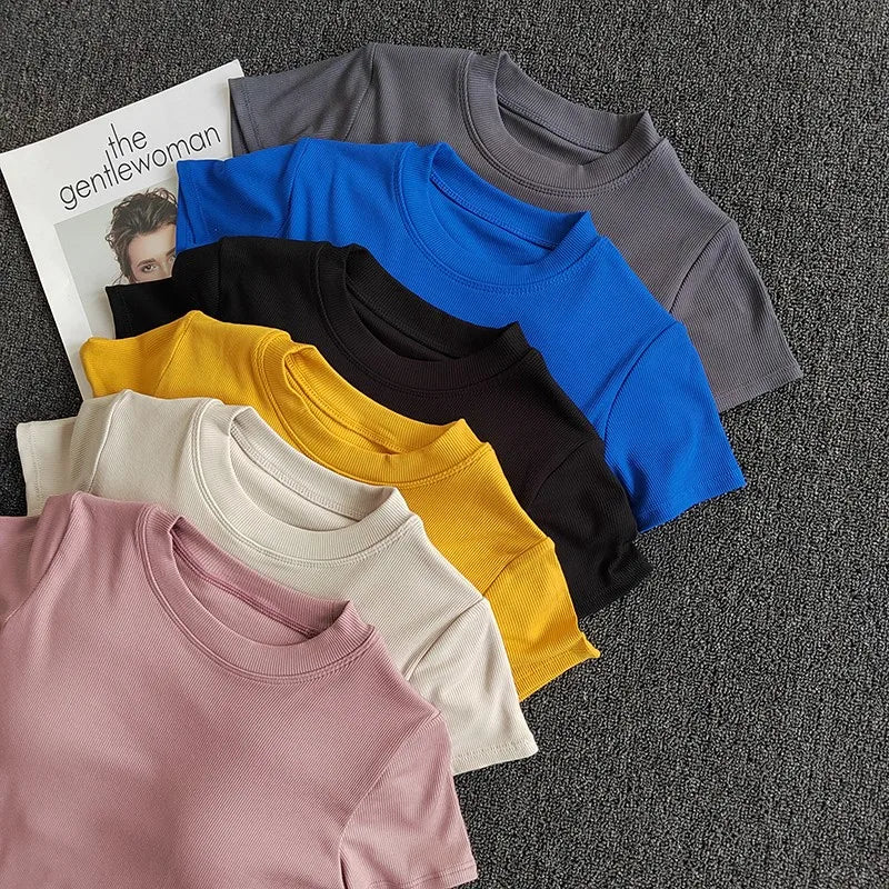 Variety of ladies fitness crop tops in pastel and bold colors for activewear styling