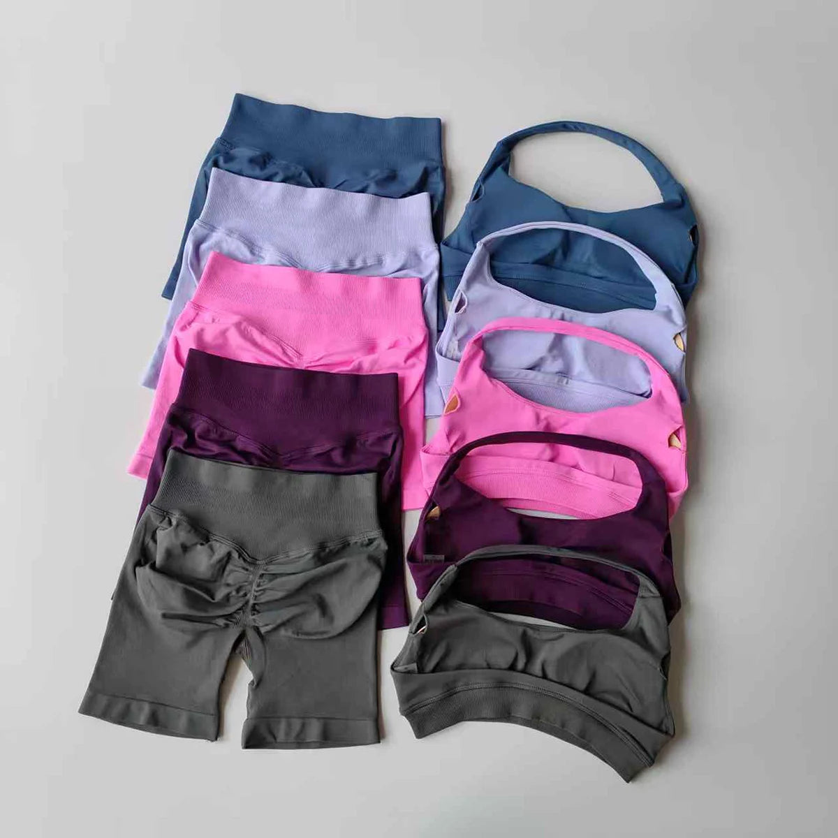 Colorful ladies fitness outfit matching set including tops and bottoms in various shades and styles