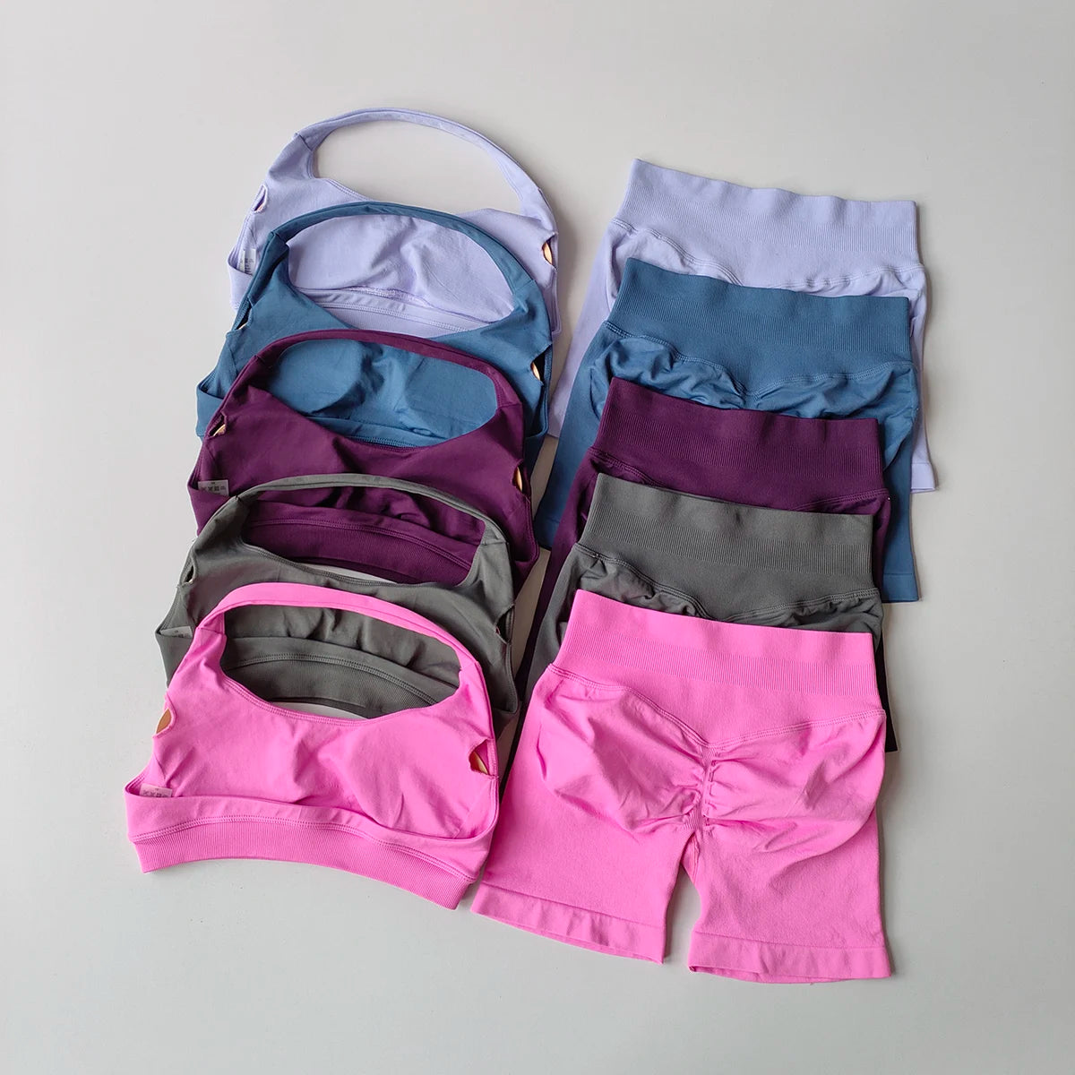 Colorful ladies fitness outfit matching set including sports bras and shorts in various shades