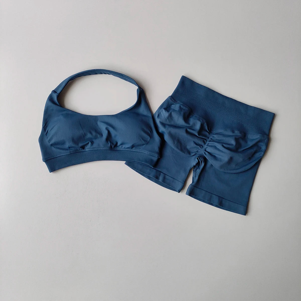 Ladies fitness outfit matching set in blue featuring a stylish sports bra and high-waisted shorts