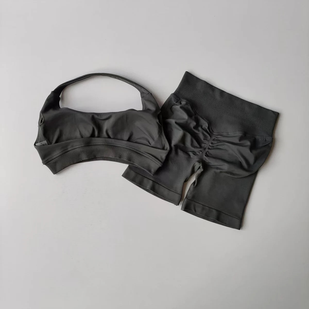 Ladies fitness outfit matching set in dark gray featuring a cropped top and high-waisted shorts
