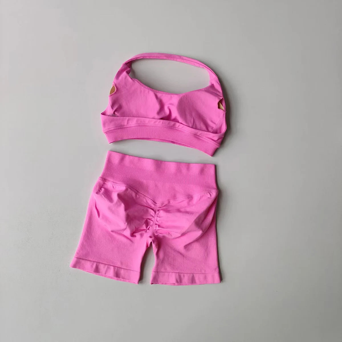 Pink ladies fitness outfit matching set with a stylish crop top and bike shorts for active wear
