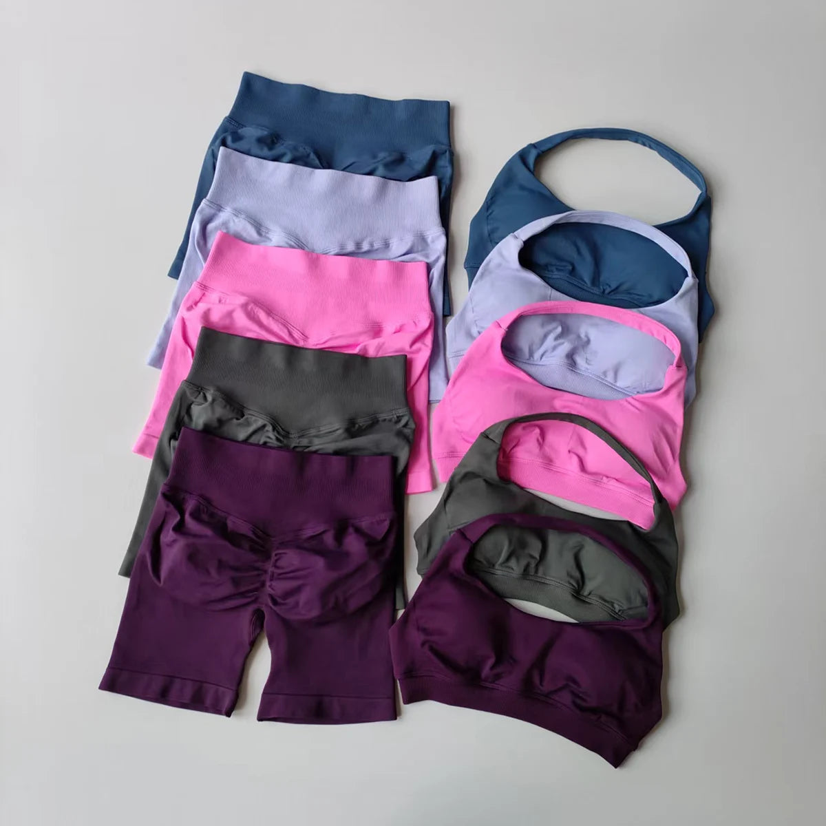 Colorful collection of ladies fitness outfit matching set including various sports bras and shorts