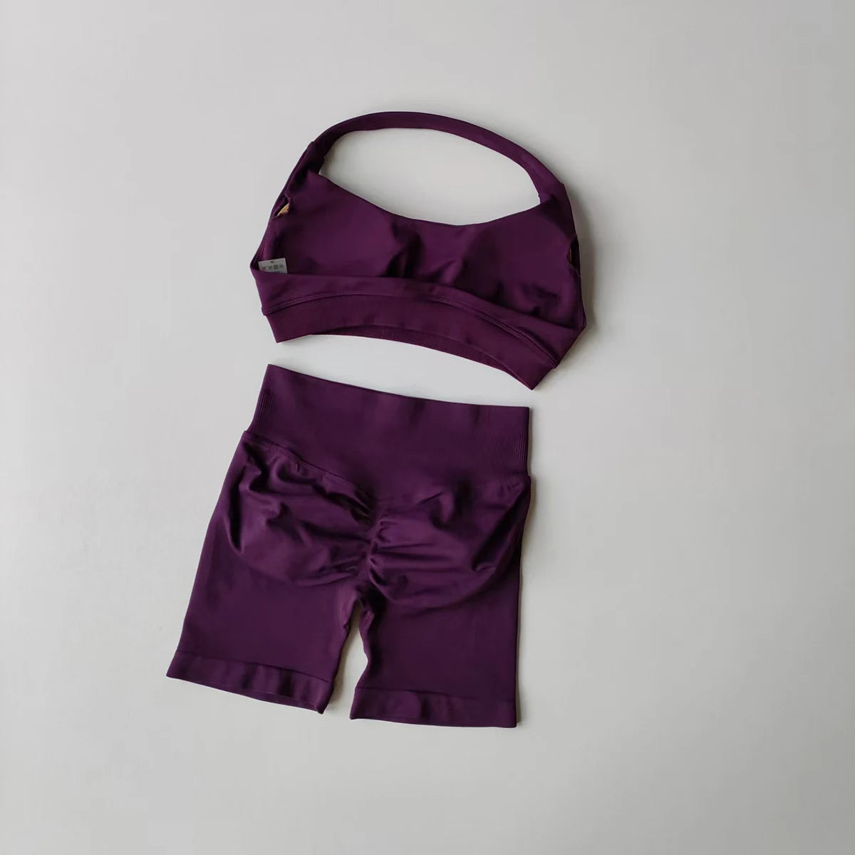 Ladies fitness outfit matching set in purple with a stylish sports bra and fitted shorts