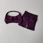 Ladies fitness outfit matching set in purple with a stylish sports bra and high-waisted shorts
