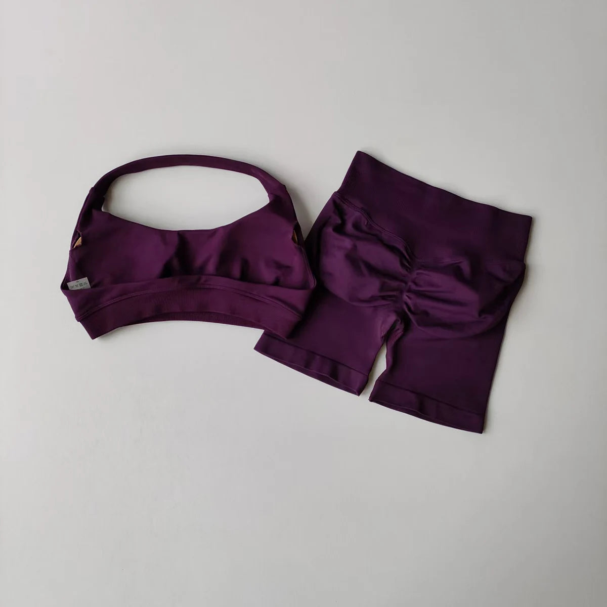 Ladies fitness outfit matching set in purple with a stylish sports bra and high-waisted shorts