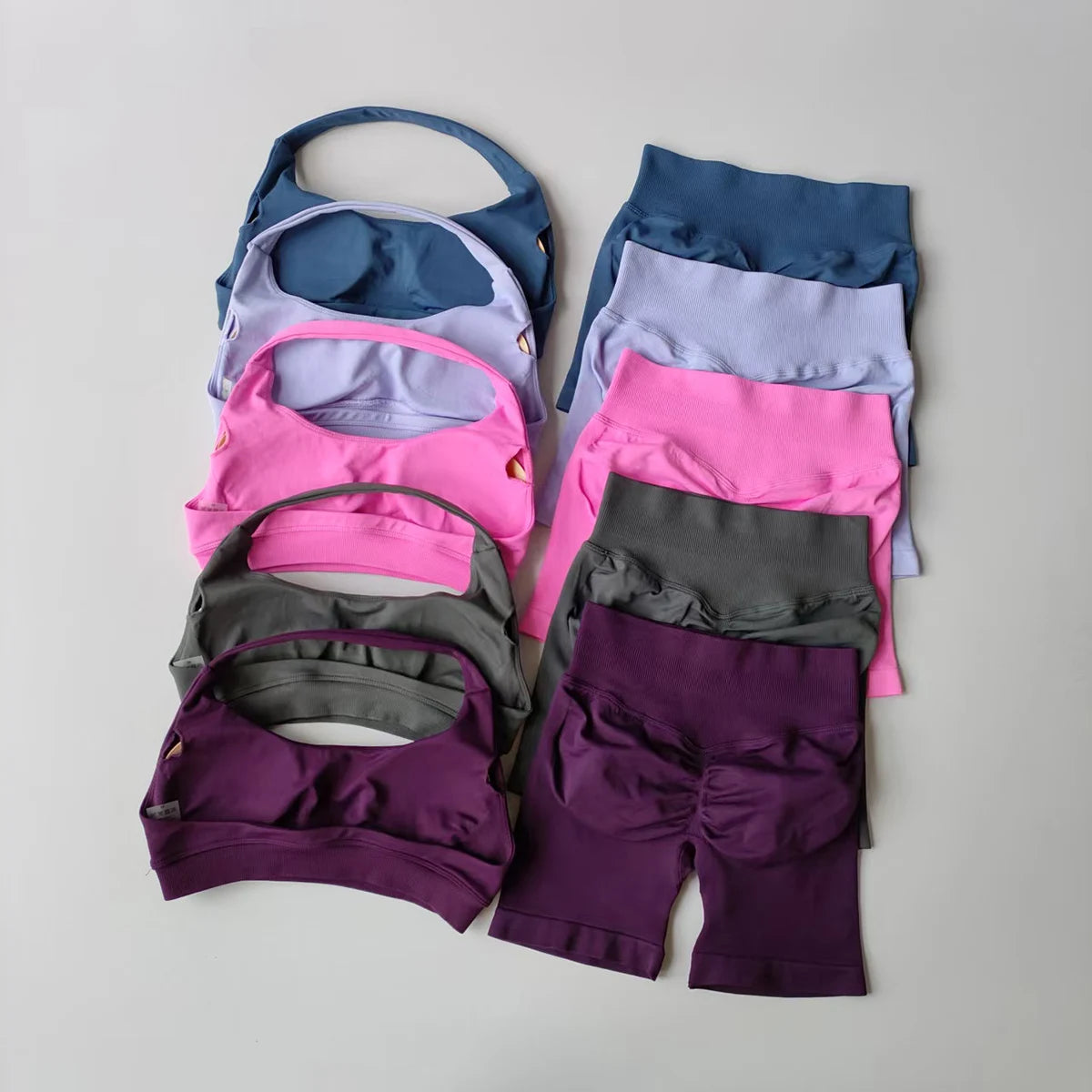 Colorful ladies fitness outfit matching set including sports bras and shorts in various colors
