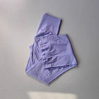 Light purple ladies fitness sweat pants folded neatly for activewear and comfortable workouts