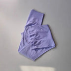 Light purple ladies fitness sweat pants folded neatly for comfortable workouts and lounging