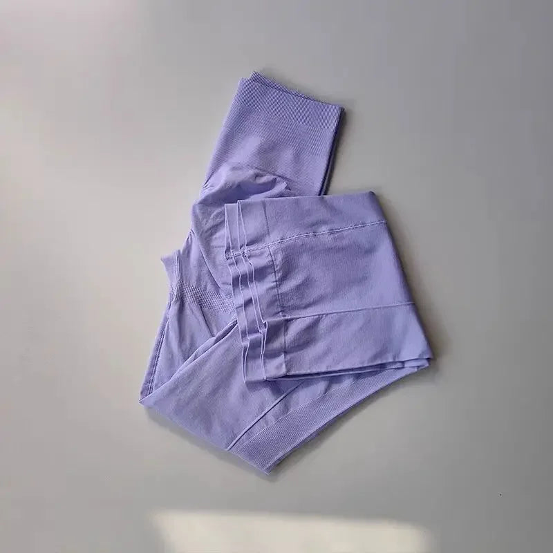 Light purple ladies fitness sweat pants folded neatly for comfortable workouts and lounging