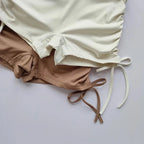 Ladies high waist workout shorts in beige and cream with stylish side ties for comfort and flexibility