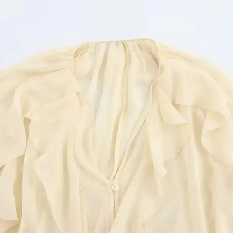 Cream sheer fabric with ruffles detail of long sleeve fashionable blouses from The Lady's Haven Boutique