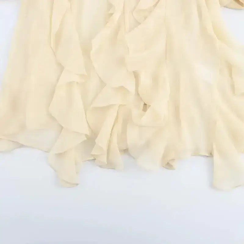 Light cream fabric with ruffled details from long sleeve fashionable blouses by The Lady's Haven Boutique