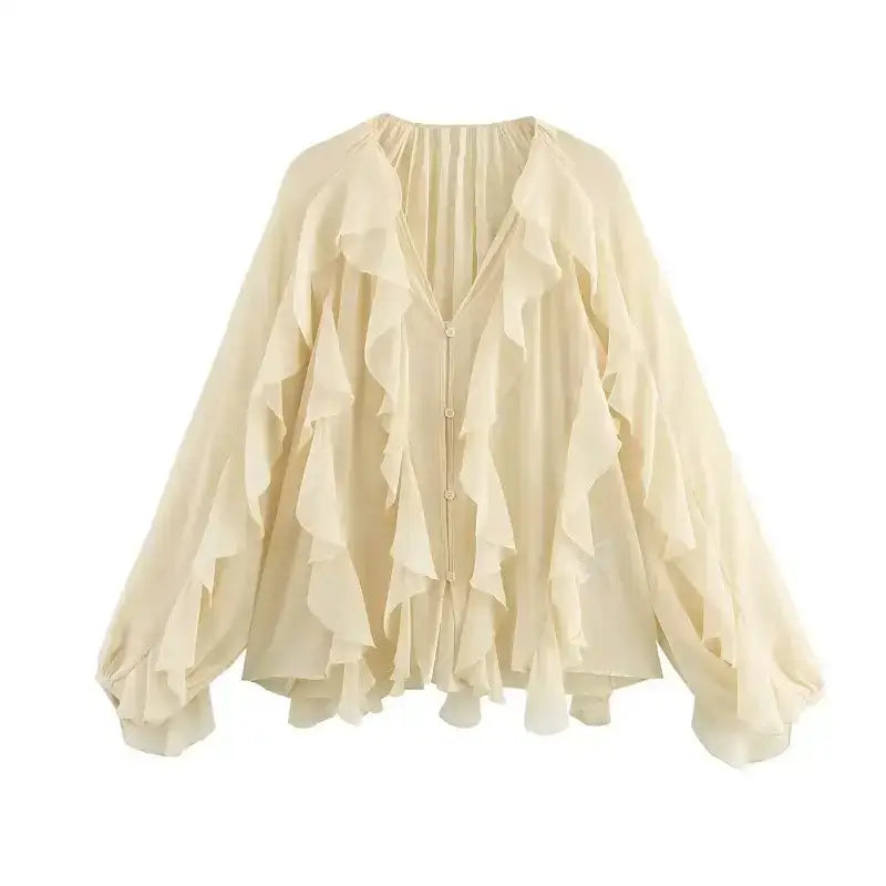Cream long sleeve fashionable blouses with ruffle details and flowy design from The Lady's Haven Boutique