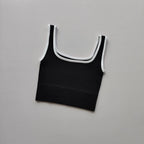 Ladies seamless yoga vest in black with white trim, perfect for comfortable workouts