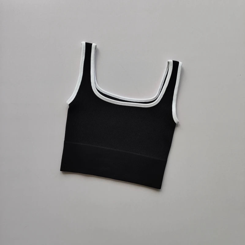 Ladies seamless yoga vest in black with white trim, perfect for comfortable workouts