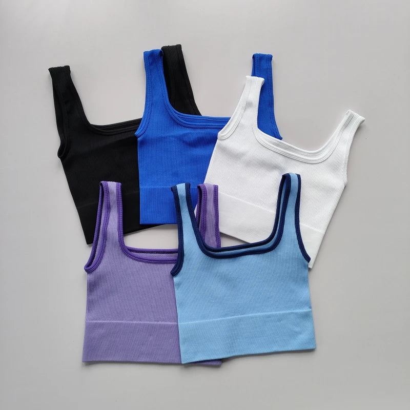 Variety of Ladies seamless yoga vests in black, blue, white, purple, and light blue colors