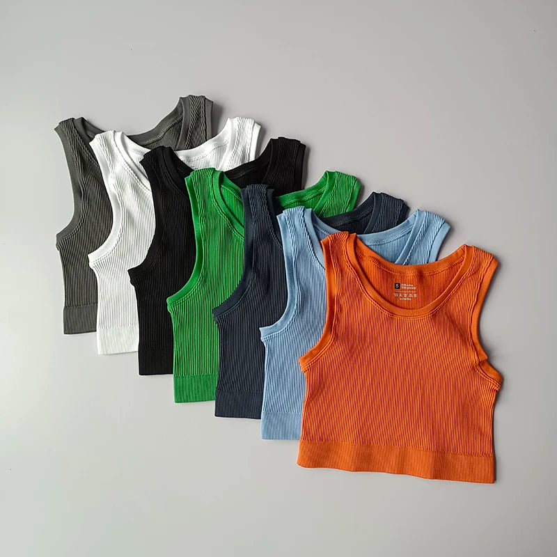 Variety of Ladies seamless yoga vests in multiple colors including orange, green, and black for stylish workouts