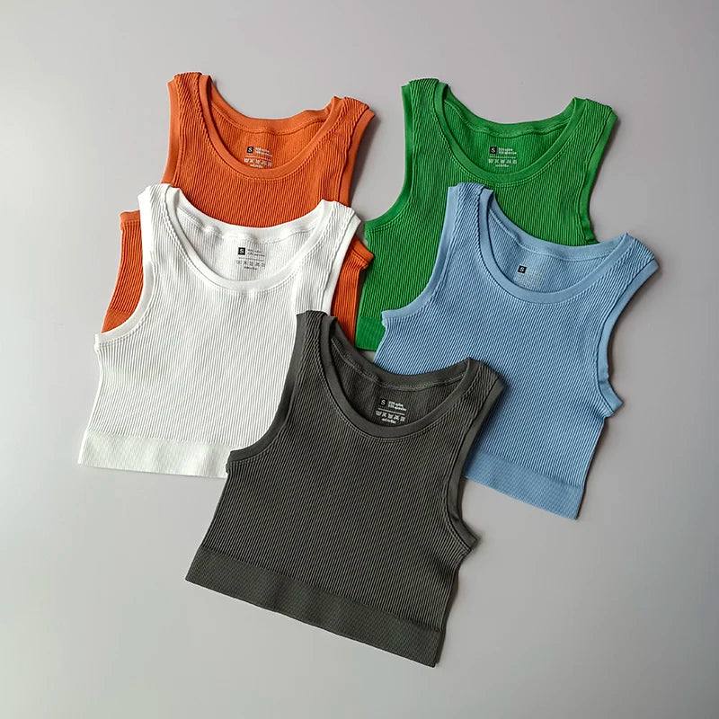 Ladies seamless yoga vest collection in multiple colors including orange, green, blue, white, and gray