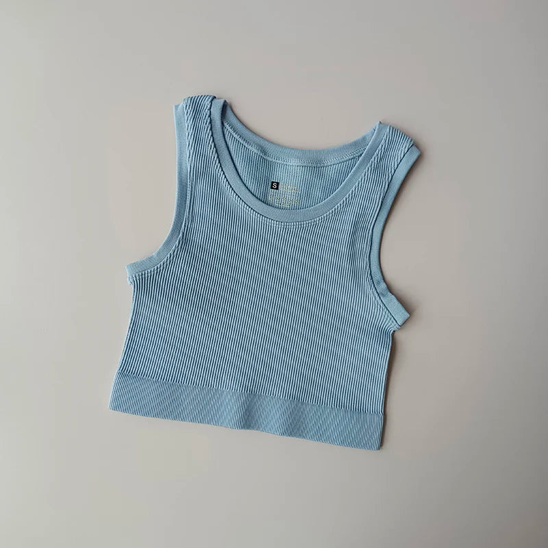 Ladies seamless yoga vest in soft blue color with a ribbed texture for comfortable workouts
