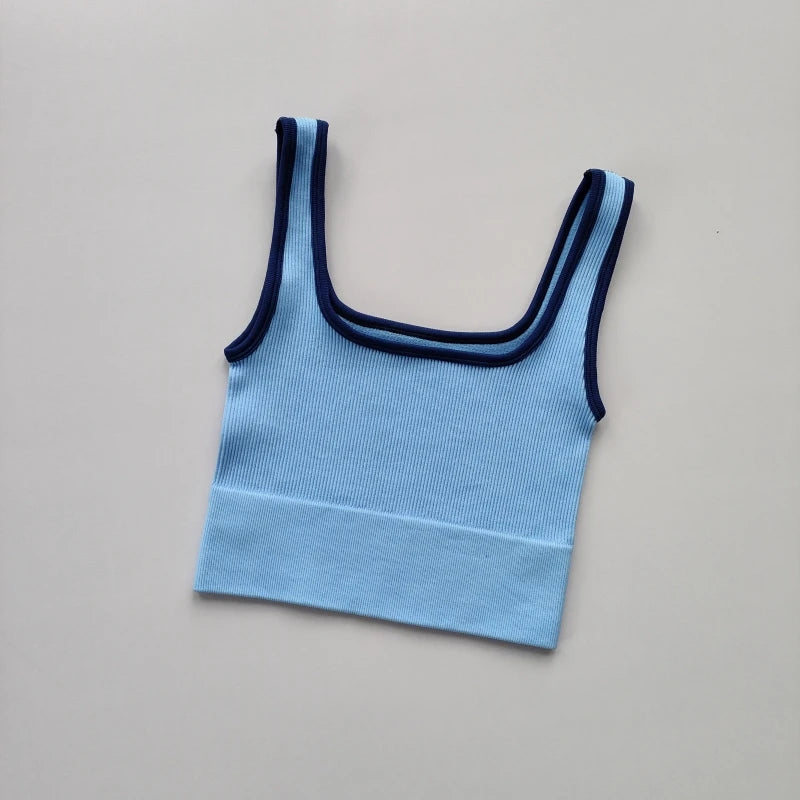 Ladies seamless yoga vest in light blue with navy trim for comfortable workout sessions