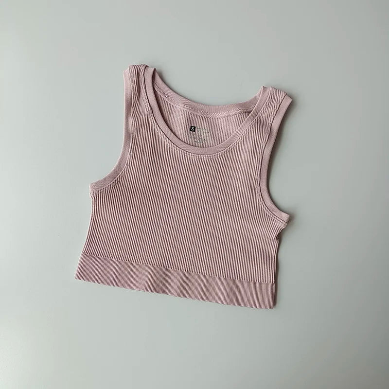 Ladies seamless yoga vest in soft pink ribbed fabric for comfortable workouts and casual wear