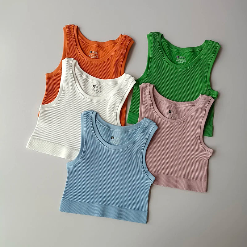 Five colorful ladies seamless yoga vests in orange, white, green, pink, and blue for comfortable workouts