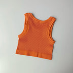 Ladies seamless yoga vest in vibrant orange with a comfortable ribbed design for active workouts