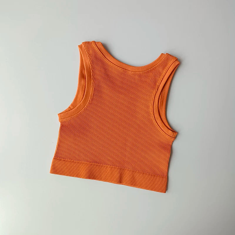 Ladies seamless yoga vest in vibrant orange with a comfortable ribbed design for active workouts