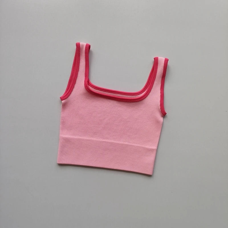 Ladies seamless yoga vest in pink with contrasting straps for comfortable workouts
