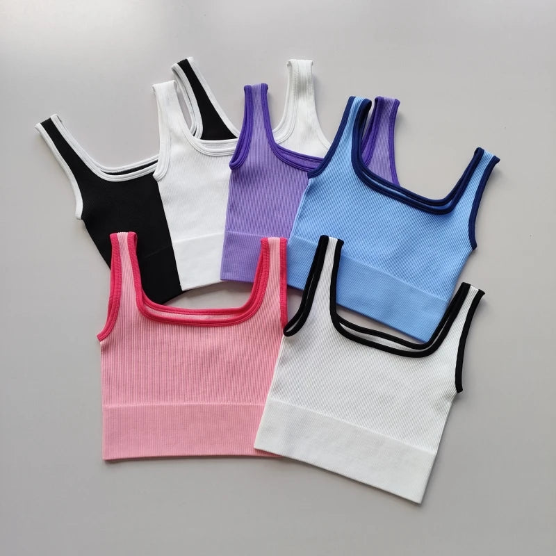 Set of six ladies seamless yoga vests in various colors including black, white, pink, and blue